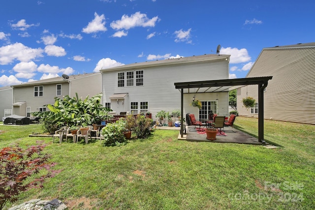 back of property featuring a patio area, a pergola, and a yard