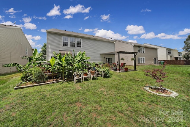 back of house with a lawn and a patio