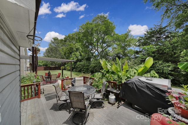 deck with a grill and a yard