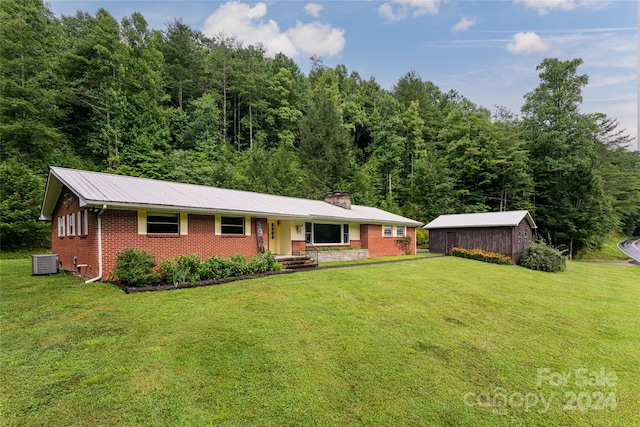 single story home with central AC unit and a front yard