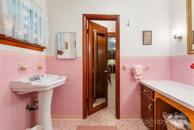 bathroom featuring tile patterned flooring, tile walls, and backsplash