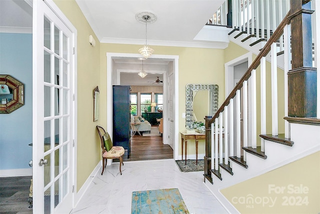 foyer with french doors and ornamental molding