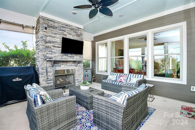 view of patio / terrace featuring a grill and an outdoor living space with a fireplace