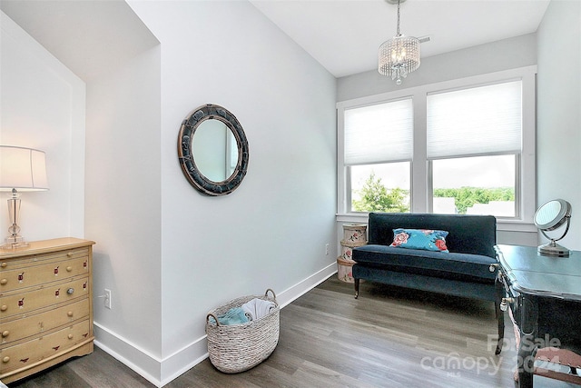 sitting room featuring a chandelier and dark hardwood / wood-style floors