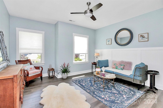 sitting room with ceiling fan and dark hardwood / wood-style floors