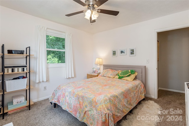 bedroom featuring light carpet and ceiling fan