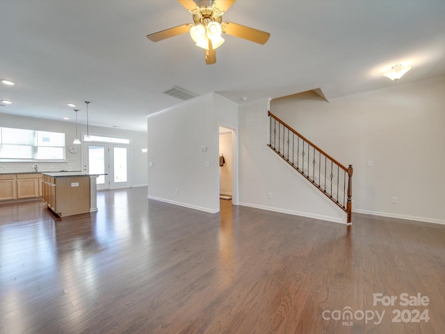 unfurnished living room with ceiling fan and dark hardwood / wood-style floors