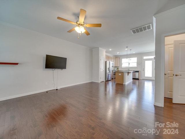 unfurnished living room featuring ceiling fan and dark hardwood / wood-style flooring