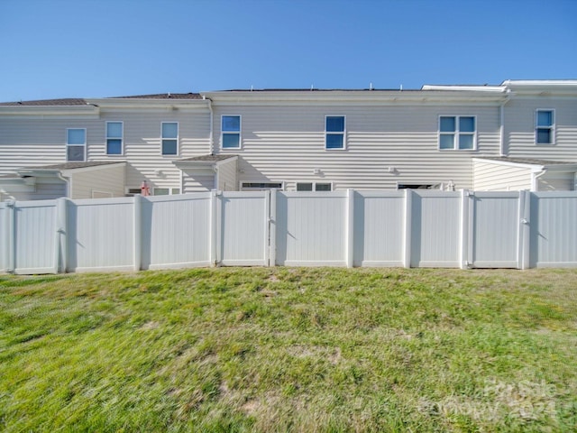 rear view of property with a yard