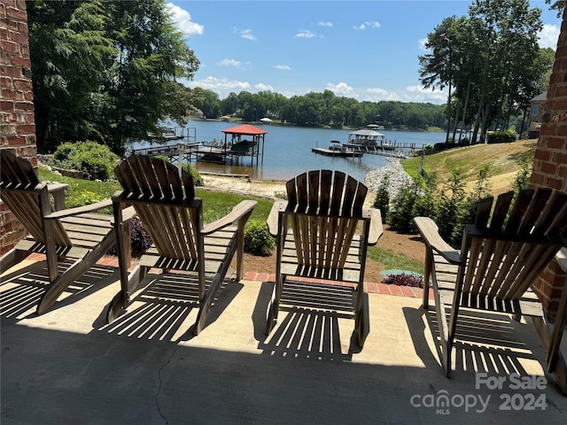 view of patio / terrace with a boat dock and a water view