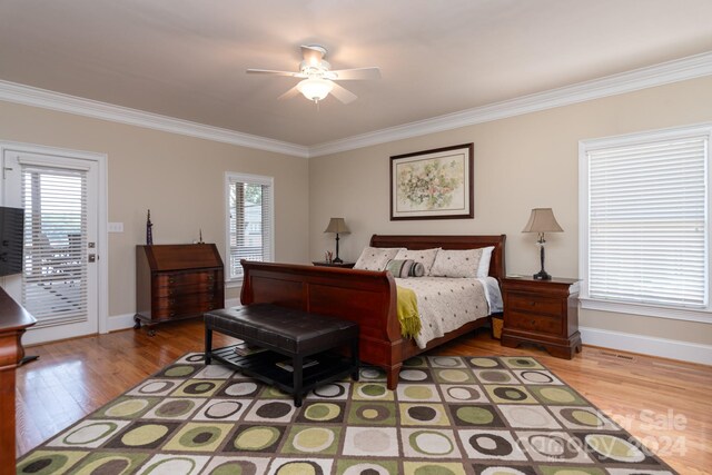 bedroom with hardwood / wood-style floors, ceiling fan, ornamental molding, and access to outside