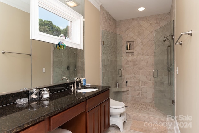 bathroom featuring tile patterned floors, vanity, toilet, and a shower with shower door