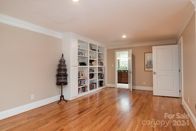 unfurnished room with light wood-type flooring and ornamental molding