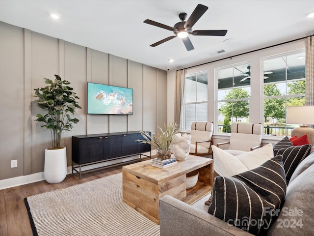 living room with ceiling fan and wood-type flooring