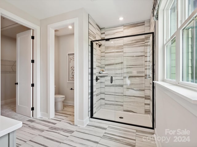 bathroom featuring toilet and walk in shower