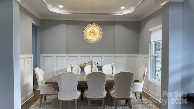 dining area with a raised ceiling, a wealth of natural light, and a notable chandelier