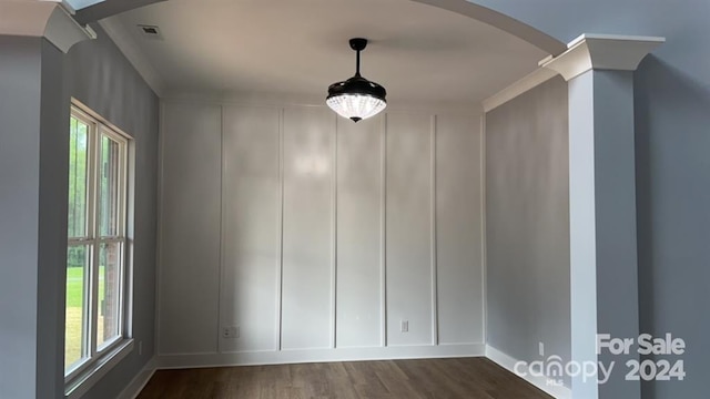 empty room with dark hardwood / wood-style flooring