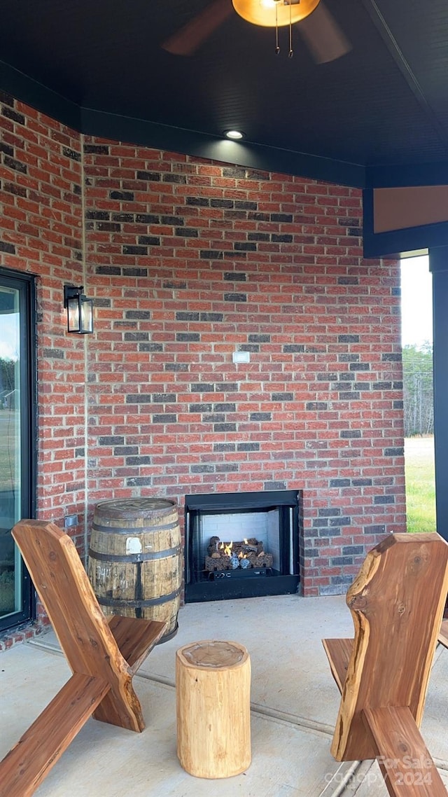 interior space featuring brick wall and a multi sided fireplace