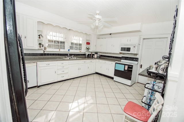 kitchen with white appliances, white cabinets, sink, ceiling fan, and light tile patterned floors