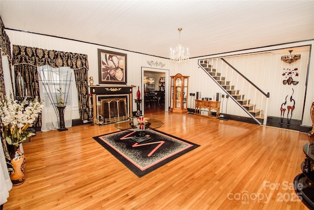 living room featuring an inviting chandelier and hardwood / wood-style flooring