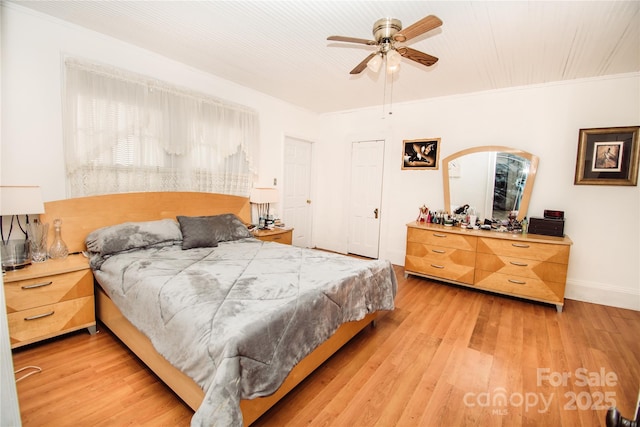 bedroom featuring ceiling fan, ornamental molding, and light hardwood / wood-style flooring