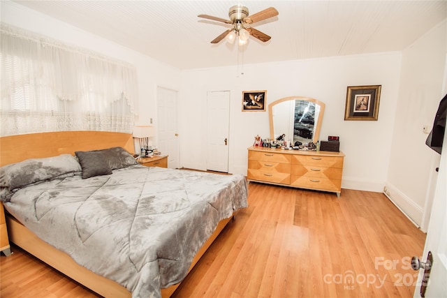 bedroom with light wood-type flooring and ceiling fan