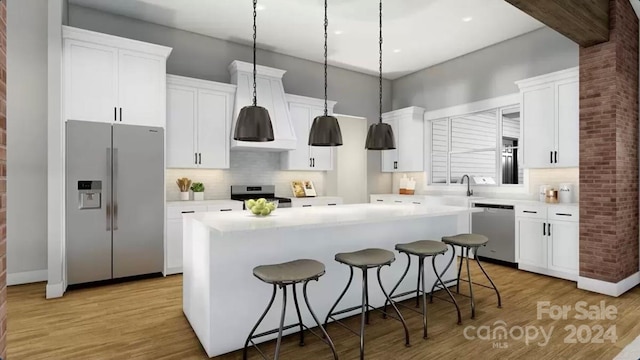 kitchen featuring white cabinets, a kitchen island, light hardwood / wood-style floors, and appliances with stainless steel finishes