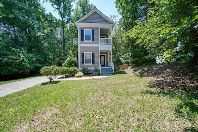 view of front of house with a balcony and a front yard