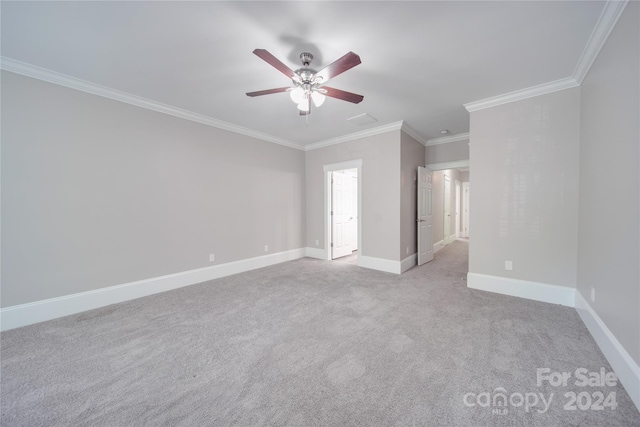 carpeted empty room featuring ornamental molding and ceiling fan