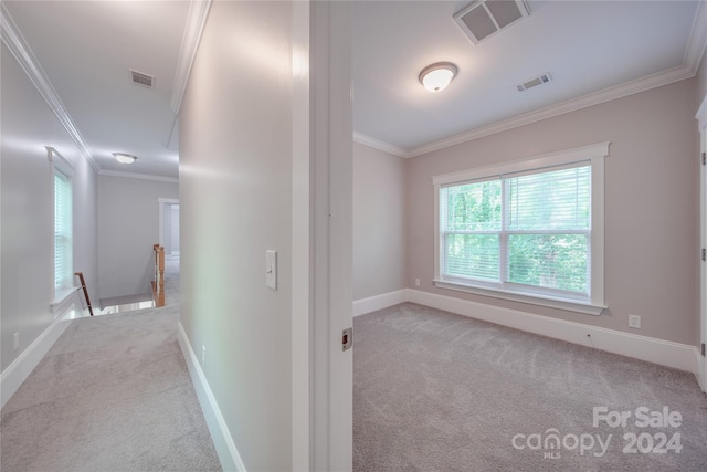 hallway with light carpet and crown molding