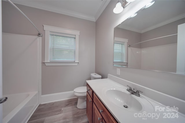 full bathroom featuring washtub / shower combination, toilet, ornamental molding, vanity, and hardwood / wood-style floors