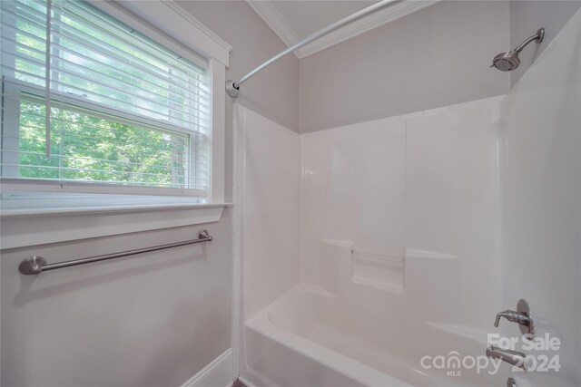 bathroom featuring crown molding and tub / shower combination