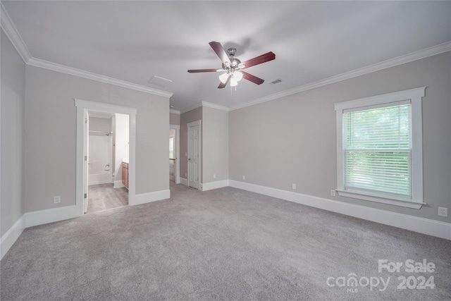 unfurnished bedroom with ceiling fan, light colored carpet, ornamental molding, and ensuite bathroom