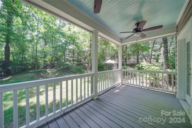 wooden deck featuring ceiling fan