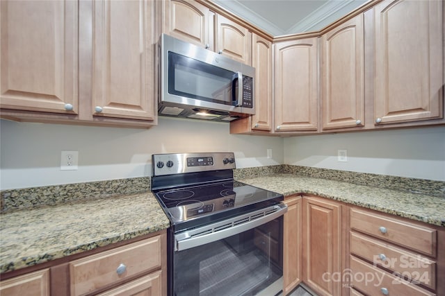 kitchen with appliances with stainless steel finishes and light stone countertops