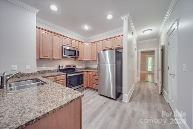 kitchen with appliances with stainless steel finishes, stone countertops, sink, light hardwood / wood-style floors, and crown molding