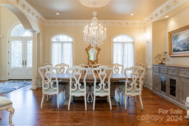 dining room featuring dark hardwood / wood-style floors, ornamental molding, french doors, and a chandelier