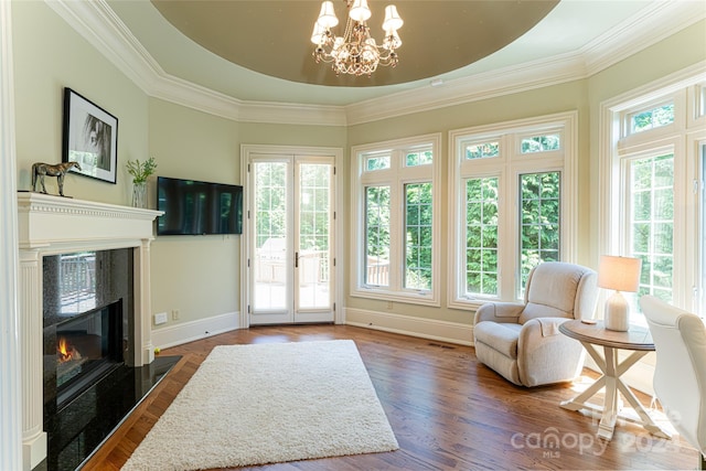 sunroom / solarium featuring a high end fireplace and a chandelier