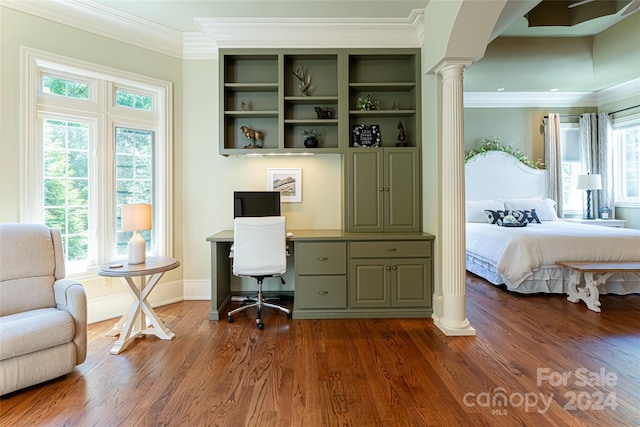 interior space with dark hardwood / wood-style flooring, built in desk, and ornamental molding