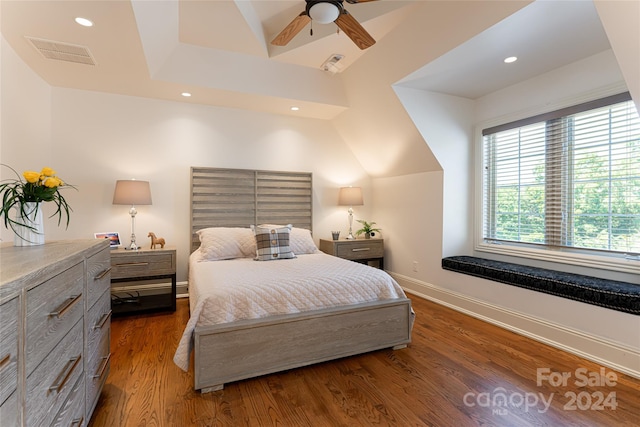 bedroom featuring ceiling fan, dark hardwood / wood-style flooring, and lofted ceiling