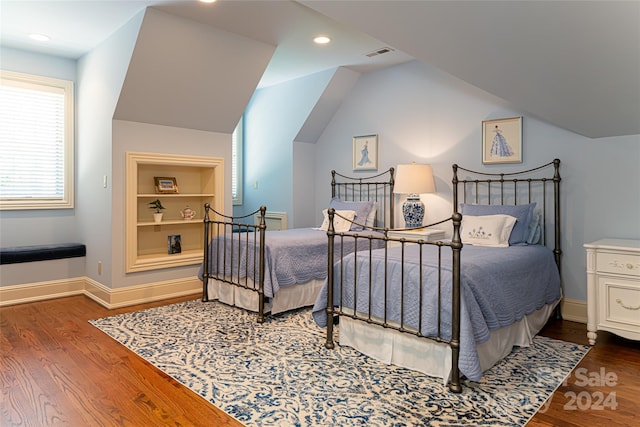 bedroom featuring vaulted ceiling and dark wood-type flooring