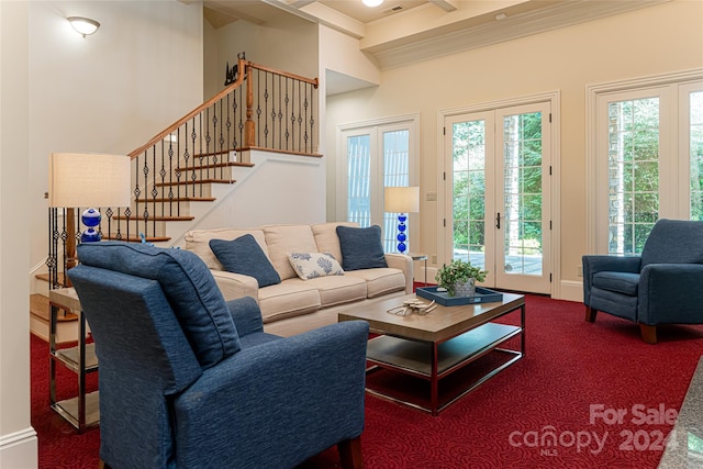 living room with carpet floors, crown molding, and french doors