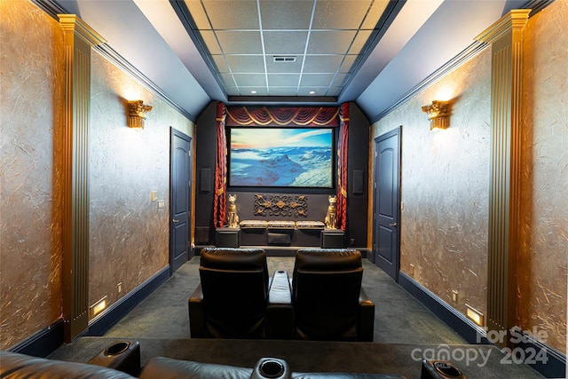 carpeted cinema room with decorative columns and a drop ceiling