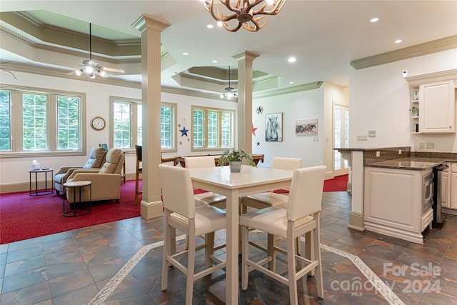 dining room with ceiling fan with notable chandelier, ornamental molding, and a tray ceiling