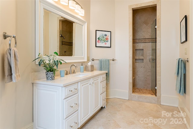 bathroom featuring tile patterned flooring, vanity, and a shower with shower door