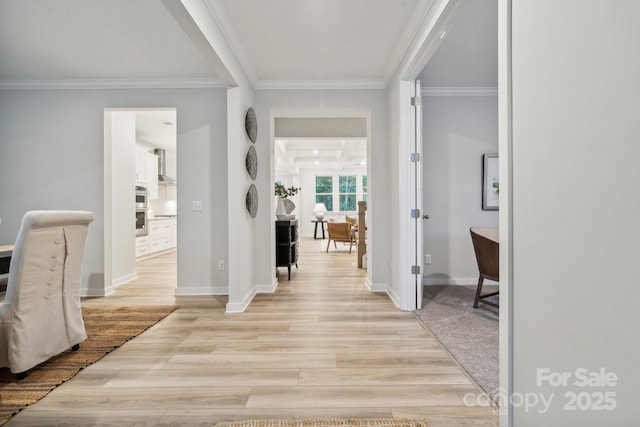 hall featuring crown molding and light wood-type flooring