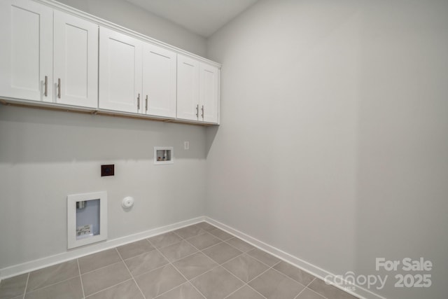 washroom featuring gas dryer hookup, hookup for a washing machine, cabinets, and light tile patterned flooring