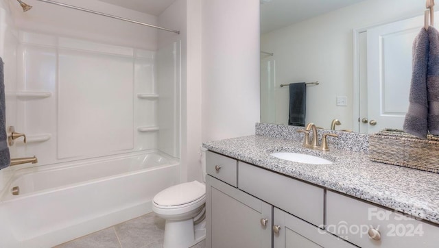 full bathroom featuring washtub / shower combination, tile patterned floors, vanity, and toilet