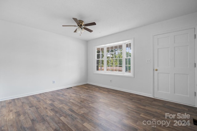 unfurnished room with dark hardwood / wood-style floors and ceiling fan