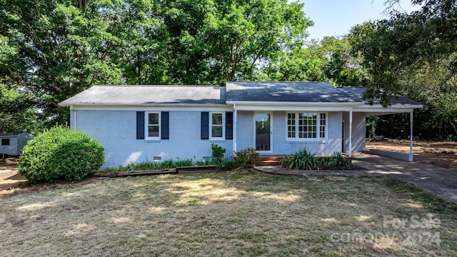 single story home featuring a carport and a front yard